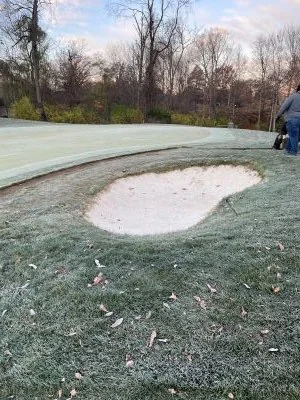Frost-covered turf around a sand bunker
